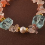 Close-up of the bracelet’s Fire Quartz bead, revealing rich reddish hues and subtle internal patterns.