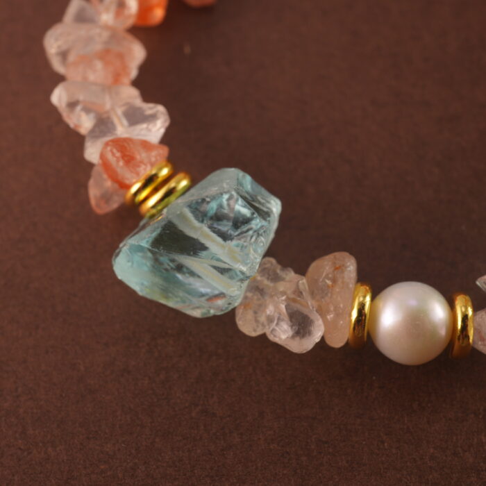Close-up of the bracelet’s Fire Quartz bead, revealing rich reddish hues and subtle internal patterns.