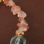 Close-up of the bracelet’s Fire Quartz bead, revealing rich reddish hues and subtle internal patterns.