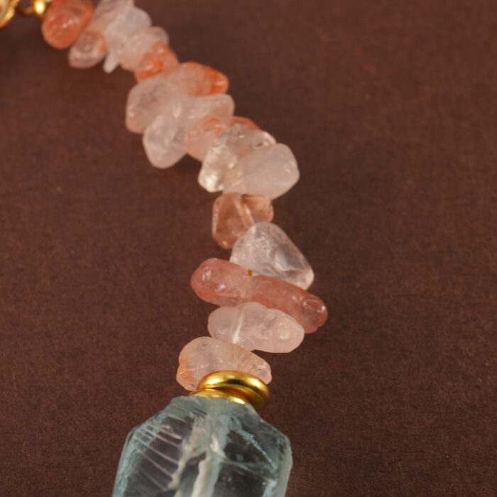 Close-up of the bracelet’s Fire Quartz bead, revealing rich reddish hues and subtle internal patterns.