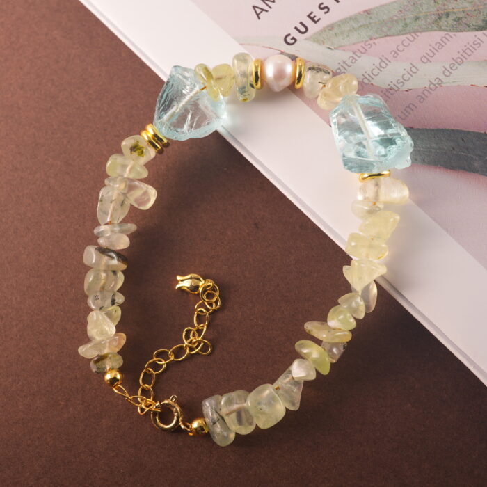 Full-view of the Pisces bracelet laid flat, featuring aquamarine, pearl, and prehnite beads in a serene, harmonious arrangement.