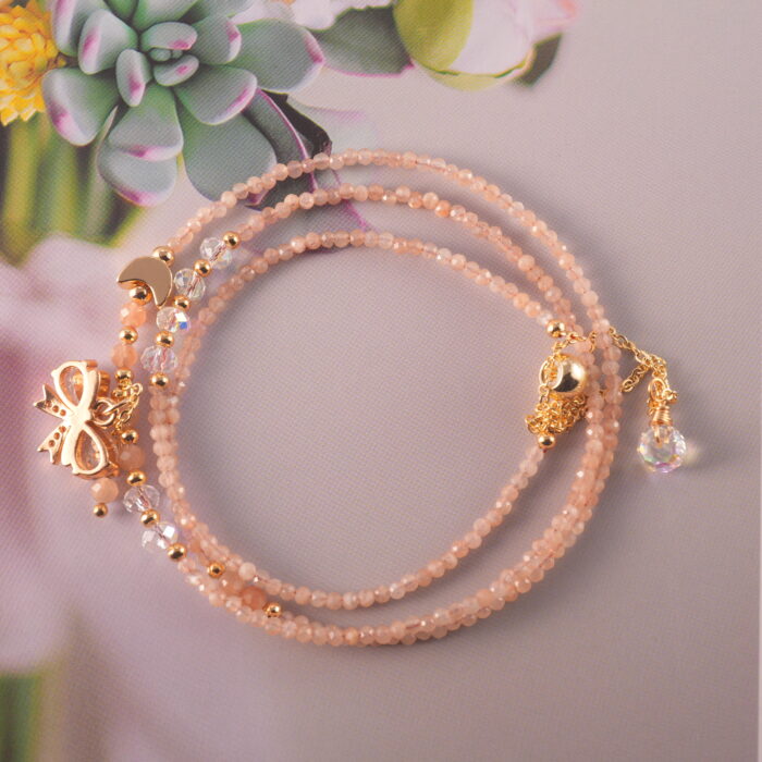 Full view of the rose quartz necklace laid flat, showing bead size and arrangement for versatile wear.