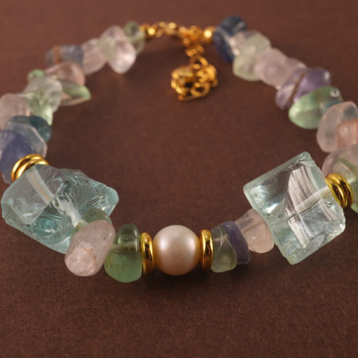 Detailed view of the Sagittarius bracelet highlighting the natural textures and subtle glow of fluorite, pearl, and aquamarine stones.