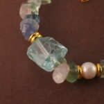 Detailed view of the Sagittarius bracelet highlighting the natural textures and subtle glow of fluorite, pearl, and aquamarine stones.