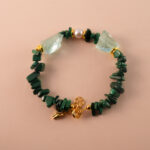 Handmade Scorpio bracelet featuring malachite, pearl, and aquamarine beads arranged in a harmonious design.