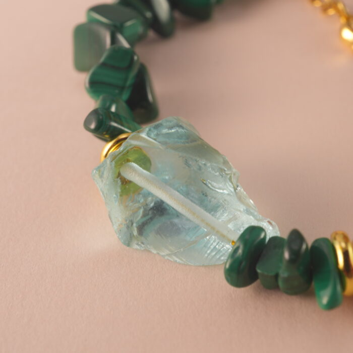 Close-up of the Scorpio bracelet highlighting the fine polish and unique patterns of malachite, pearl, and aquamarine.