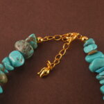 Close-up showing the texture and subtle luster of turquoise, pearl, and aquamarine beads.