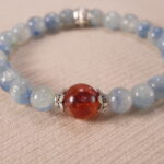 Close-up of kyanite and red agate bracelet with vivid colors.