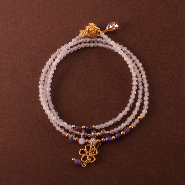 Multi-use necklace made with lavender and Uruguayan amethyst beads, shown coiled in a soft, elegant layout.