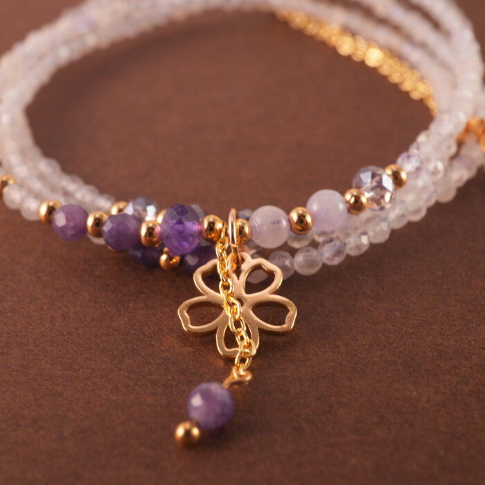 Close-up of amethyst beads highlighting their natural variation, polish, and subtle lavender hues.