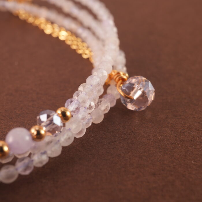 Close-up of amethyst beads highlighting their natural variation, polish, and subtle lavender hues.
