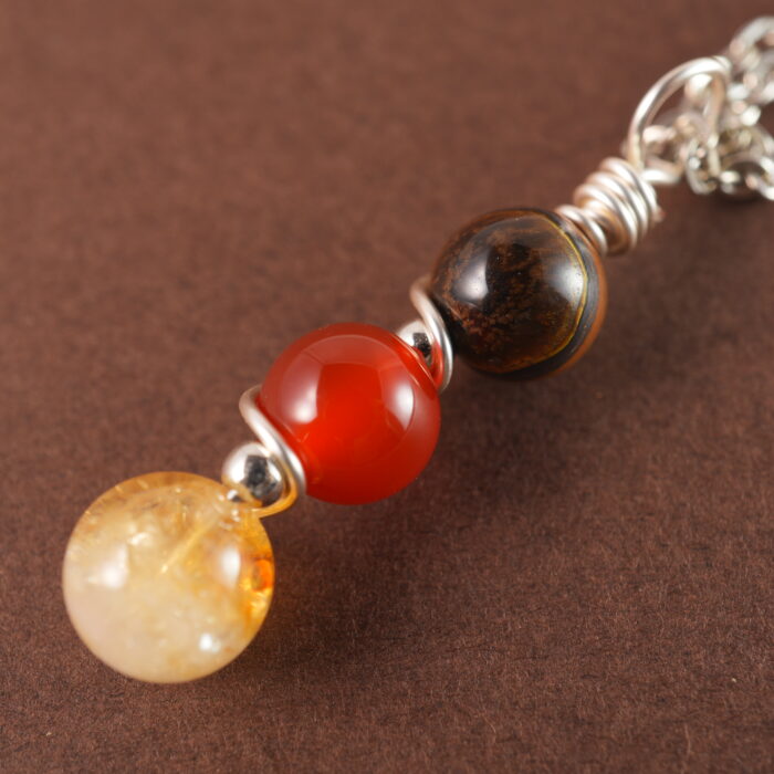 Detailed view of Leo necklace featuring tiger eye, red jasper, and citrine.