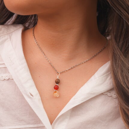 Model wearing Leo zodiac necklace with natural gemstones.