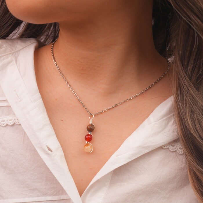 Model wearing Leo zodiac necklace with natural gemstones.