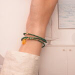 The malachite bracelet wrapped around the wrist three times, offering a bold and earthy statement look.