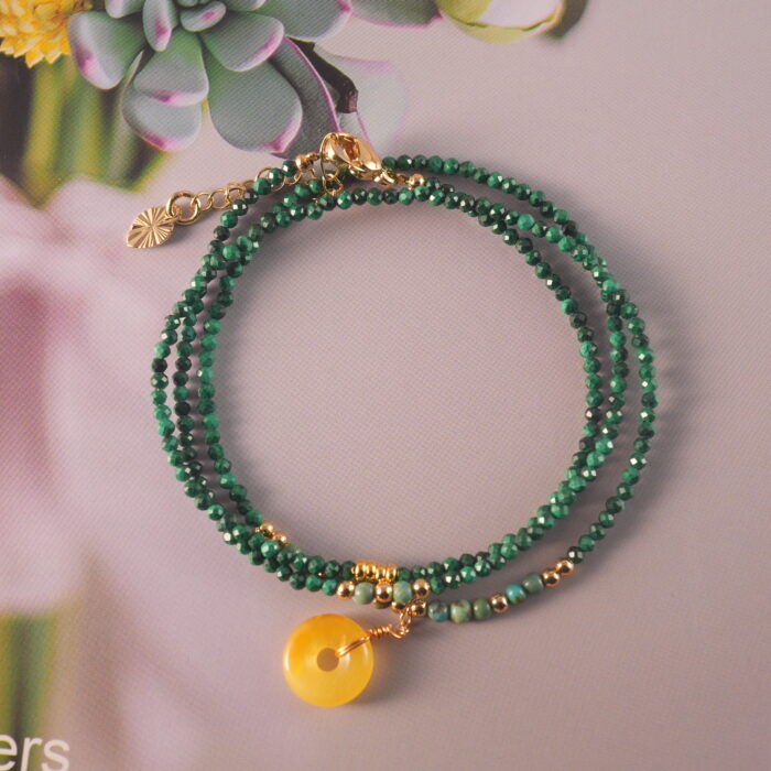 Full-length view of the malachite necklace laid out flat, showcasing uniform bead spacing and versatile design.