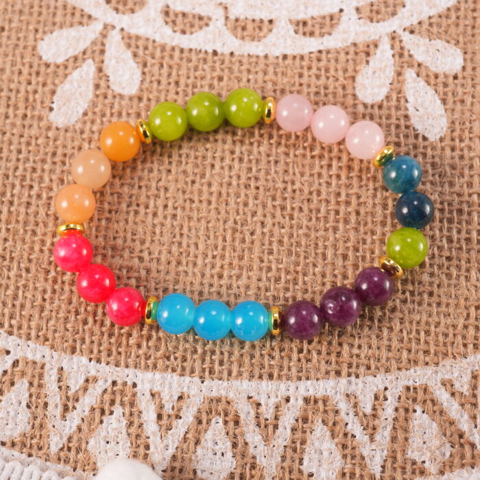 Multi-gemstone bracelet in natural light with vibrant tones.