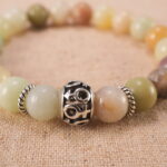Close-up of multicolor amazonite bracelet with S925 silver details.