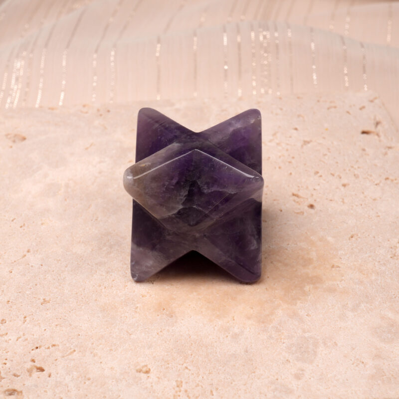 Natural Dream Amethyst Merkaba ornament displayed against a clean background, highlighting its rich purple banding.