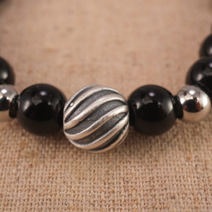 Close-up of obsidian bracelet with S925 silver spacer beads.