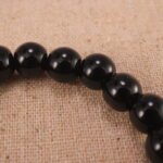 Close-up of obsidian bracelet with S925 silver spacer beads.