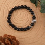 Obsidian bracelet in natural light showing deep black luster.