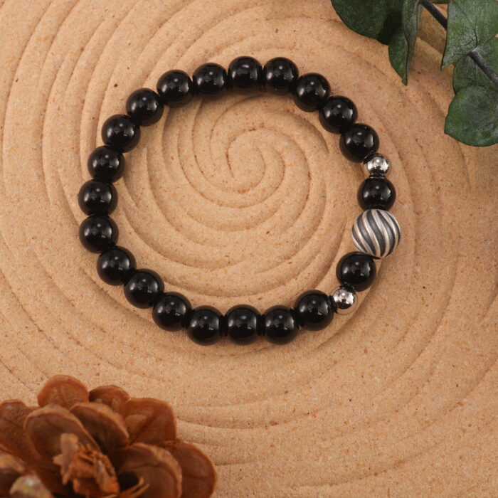Obsidian bracelet in natural light showing deep black luster.