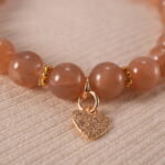 Close-up of peach moonstone bracelet.