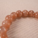 Close-up of peach moonstone bracelet.