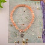 Bracelet in natural light showing soft peach glow.