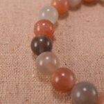 Close-up of peach moonstone and white agate bracelet with S925 silver accents.