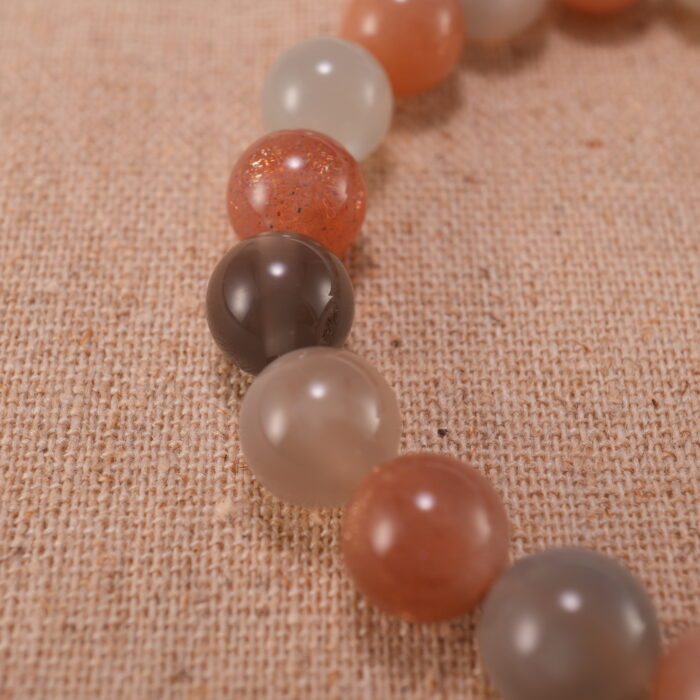 Close-up of peach moonstone and white agate bracelet with S925 silver accents.