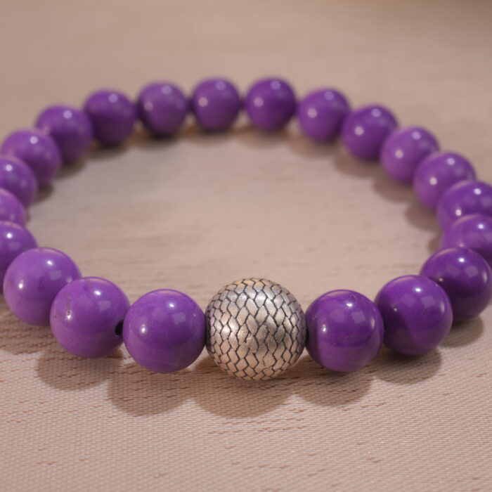 Close-up of phosphosiderite bracelet showing soft purple beads with natural luster.