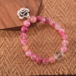 Pink chalcedony and quartz bracelet displayed in soft natural lighting.