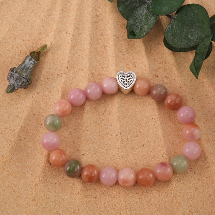 Pink agate bracelet in natural light with soft translucent beads.