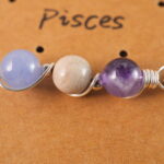 Close-up of Pisces necklace showing amethyst, crazy agate, and aquamarine beads.