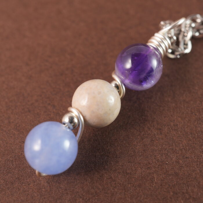 Close-up of Pisces necklace showing amethyst, crazy agate, and aquamarine beads.