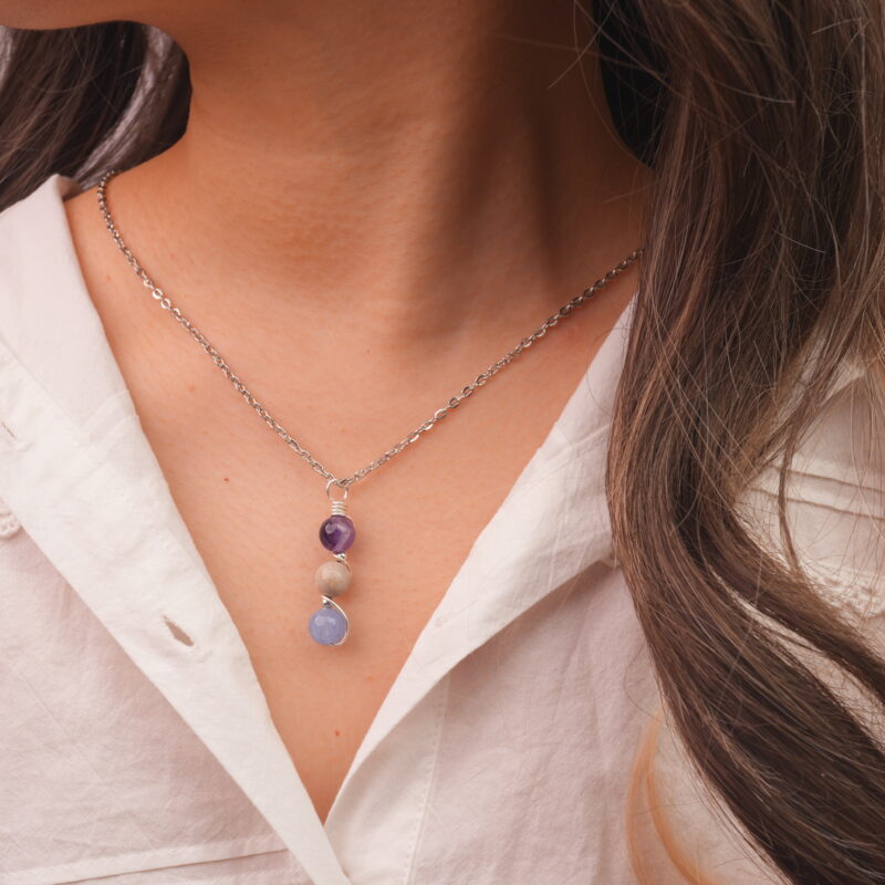 Model wearing Pisces zodiac necklace with amethyst, crazy agate, and aquamarine.