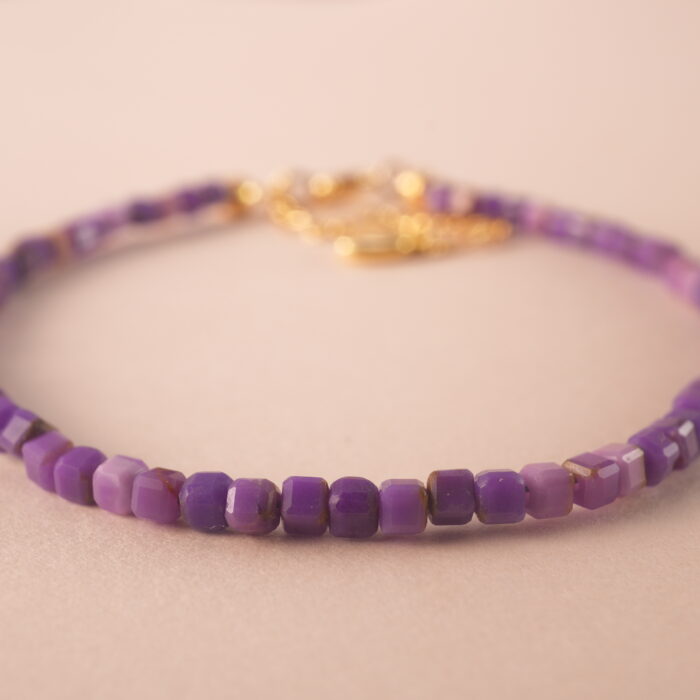 Close-up of purple chalcedony bracelet showing bead texture and clarity.