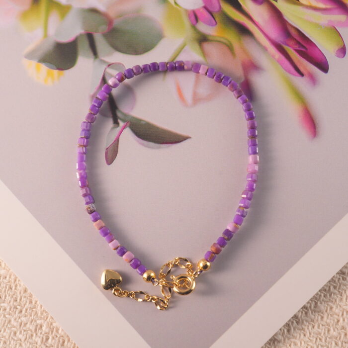 Purple chalcedony bracelet placed in natural light with soft background.