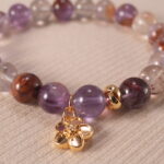 Close-up of purple phantom quartz bracelet with translucent layers.