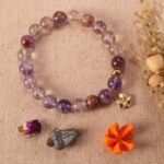 Purple phantom quartz bracelet in natural light with soft purple tones.
