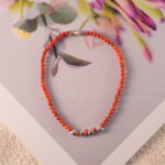 Red agate bracelet placed in soft natural light with clean background.