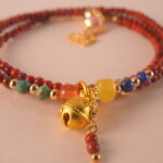 Close-up of red agate and lapis lazuli beads, showing polished surfaces and natural textures.