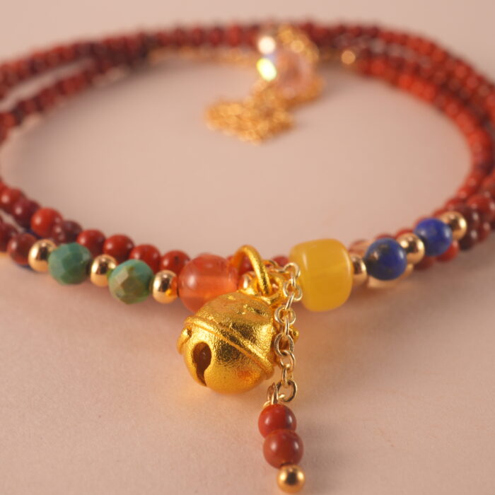 Close-up of red agate and lapis lazuli beads, showing polished surfaces and natural textures.