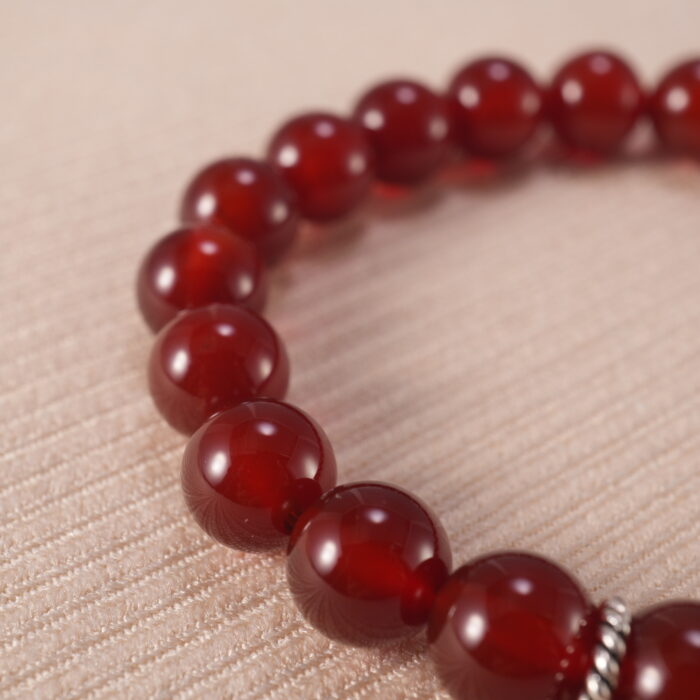 Close-up of red agate bracelet with S925 silver accents.