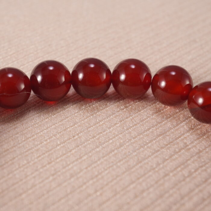 Close-up of red agate bracelet with S925 silver accents.