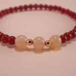 Close-up of red agate and white chalcedony bracelet.
