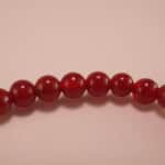 Close-up of red agate and white chalcedony bracelet.