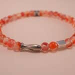 Close-up of red carnelian bracelet with silver details.